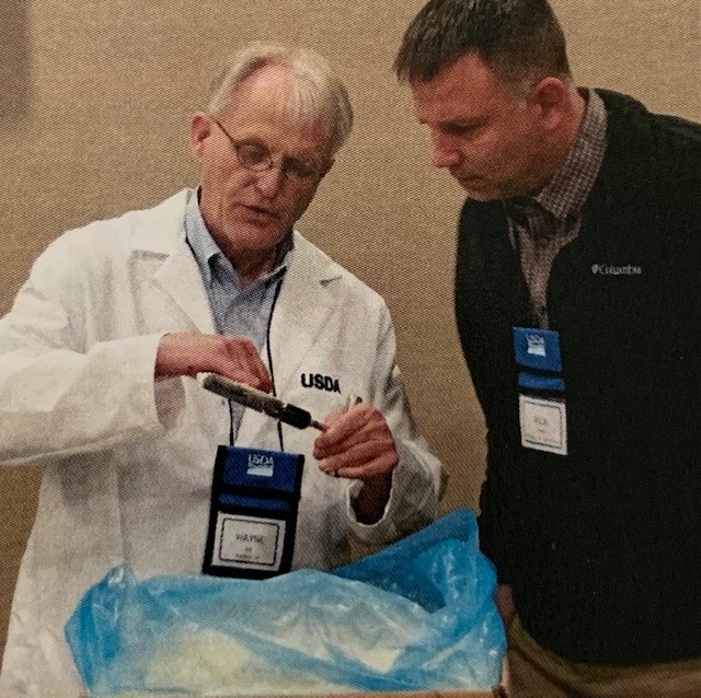 USDA grader examines a butter sample.